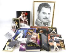 A collection of Freddy Mercury memorobillia. Including books, cassettes, a portrait, etc.