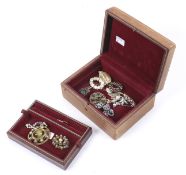 A vintage jewellery box containing vintage brooches.