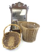 A mahogany framed wall mirror and two wicker baskets.