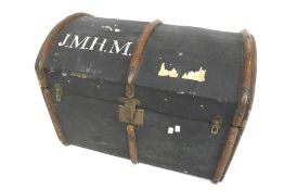 A vintage dome top trunk. With wooden and leather bindings, stamped 'J.M.H.M.