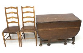 A pair of oak chairs and dropleaf gate leg table.