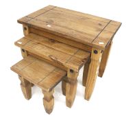 A contemporary nest of three pine tables. Of rectangular form, raised on shaped block supports, Max.