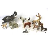 An assortment of ceramic animal figures. Including a Royal Belvedere dog, Beswick stag and doe, etc.