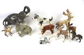 An assortment of ceramic animal figures. Including a Royal Belvedere dog, Beswick stag and doe, etc.