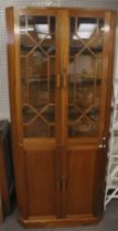 A contemporary mahogany corner cabinet.