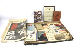 An assortment of military interest ephemera. Including books, documents, newspapers, etc.