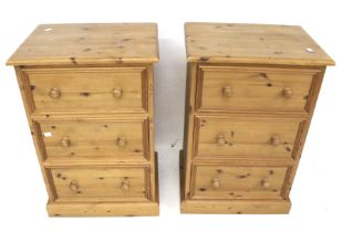 A pair of contemporary pine bedside cabinets.