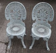 A pair of early 20th century cast metal garden chairs.