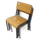Four vintage stacking classroom chairs.