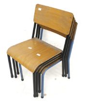 Four vintage stacking classroom chairs.