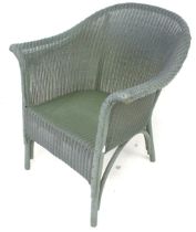 A vintage green painted Lloyd Loom tub chair. With original paper label.