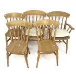 A set of five pine dining chairs.
