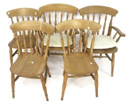 A set of five pine dining chairs.