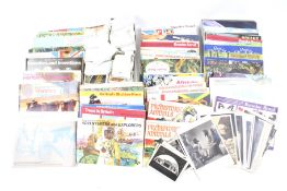 An assortment of vintage postcards and collectors cards.