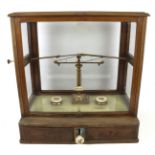 A cased set of apothecary scales by Dertling, London.