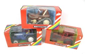 Three Britains 1:32 scale tractors.