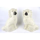 A pair of large Staffordshire spaniels. Glazed in cream with gilt details, H37.