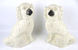 A pair of large Staffordshire spaniels. Glazed in cream with gilt details, H37.