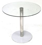 A circular glass top table. With chrome pedestal and base.