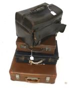 Three vintage leather suitcases and a doctor's bag.