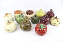 A collection of novelty storage jars modelled as fruit and vegetables.