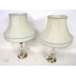 A pair of crystal and brass lamps, complete with shades and shade gimbles.