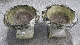 A pair of composite stone garden planters.