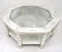 An octagonal glass topped coffee table.