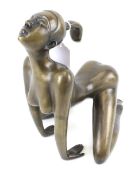 A contemporary bronze sculpture of a nude woman.