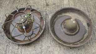 Two cast metal pig feeders.