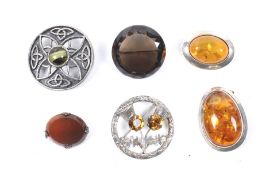 Six Scottish silver brooches. Including examples set with amber, agate and citrine.