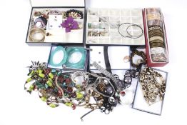 An assortment of costume jewellery. Including bangles, pairs of earrings, necklaces, etc.