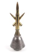 A piece of Trench Art with bullets inserted to form a star mounted on a part MK 149 rocket base.