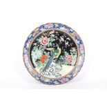 A large 20th century Japanese charger with fluted rim and decorated with pheasants and peonies.