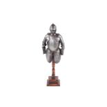 An Edwardian model scale half suit of armour mounted on a wooden base.