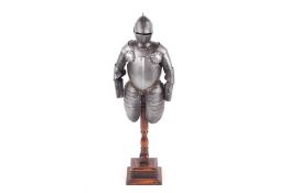 An Edwardian model scale half suit of armour mounted on a wooden base.