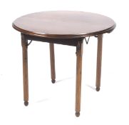 Campaign Furniture: An early 20th century/WWI walnut circular folding table.