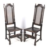 A pair of circa 1900 oak Carolean style hall chairs.