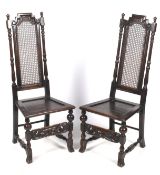 A pair of circa 1900 oak Carolean style hall chairs.