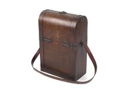 A vintage mahogany two bottle wine carrier with shoulder strap.