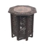 An Anglo Indian carved folding octagonal table.