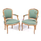 A pair of armchairs with fluted and carved details.