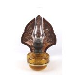 A late 19th century wall bracket with an amber glass Matador oil lamp.