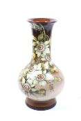 Doulton, Lambeth England : An early hand painted baluster shaped tall vase with passion flowers.