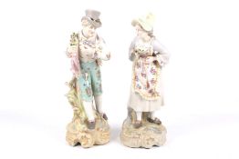 Pair of porcelain figures of a lady and a gentleman carrying a bouquet.