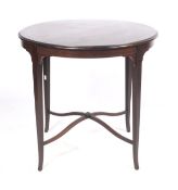 A 1920s black walnut circular centre table.