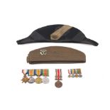 Two military hats and a group of medals.