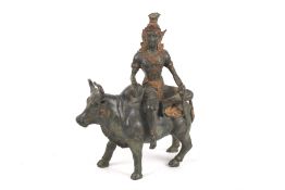 A contemporary Cambodian bronze figure of Shiva seated on a bull.