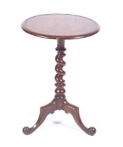 A Victorian mahogany wine table with circular top over a turned support on a tripod base. H44cm.