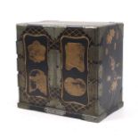 A Japanese Meiji period black and gold laquered table cabinet.